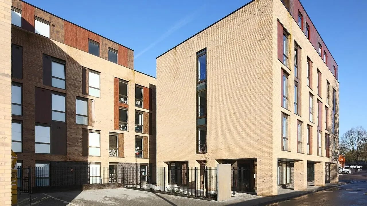 Modern brick student accommodation buildings with blue sky exterior at Collegiate Cathedral Point in Winchester Student Accommodation