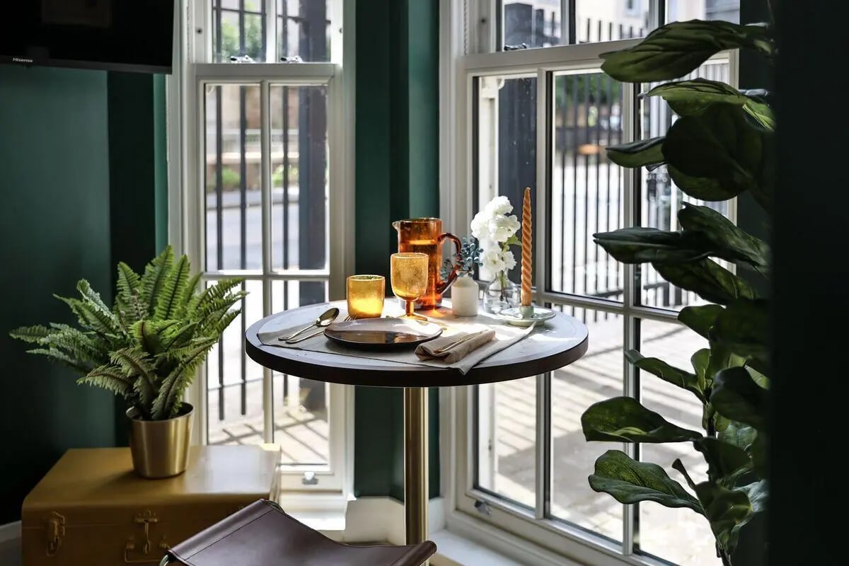 Round table with place setting and plants dining area at Talbot Postgrad Studios in Nottingham Student Accommodation