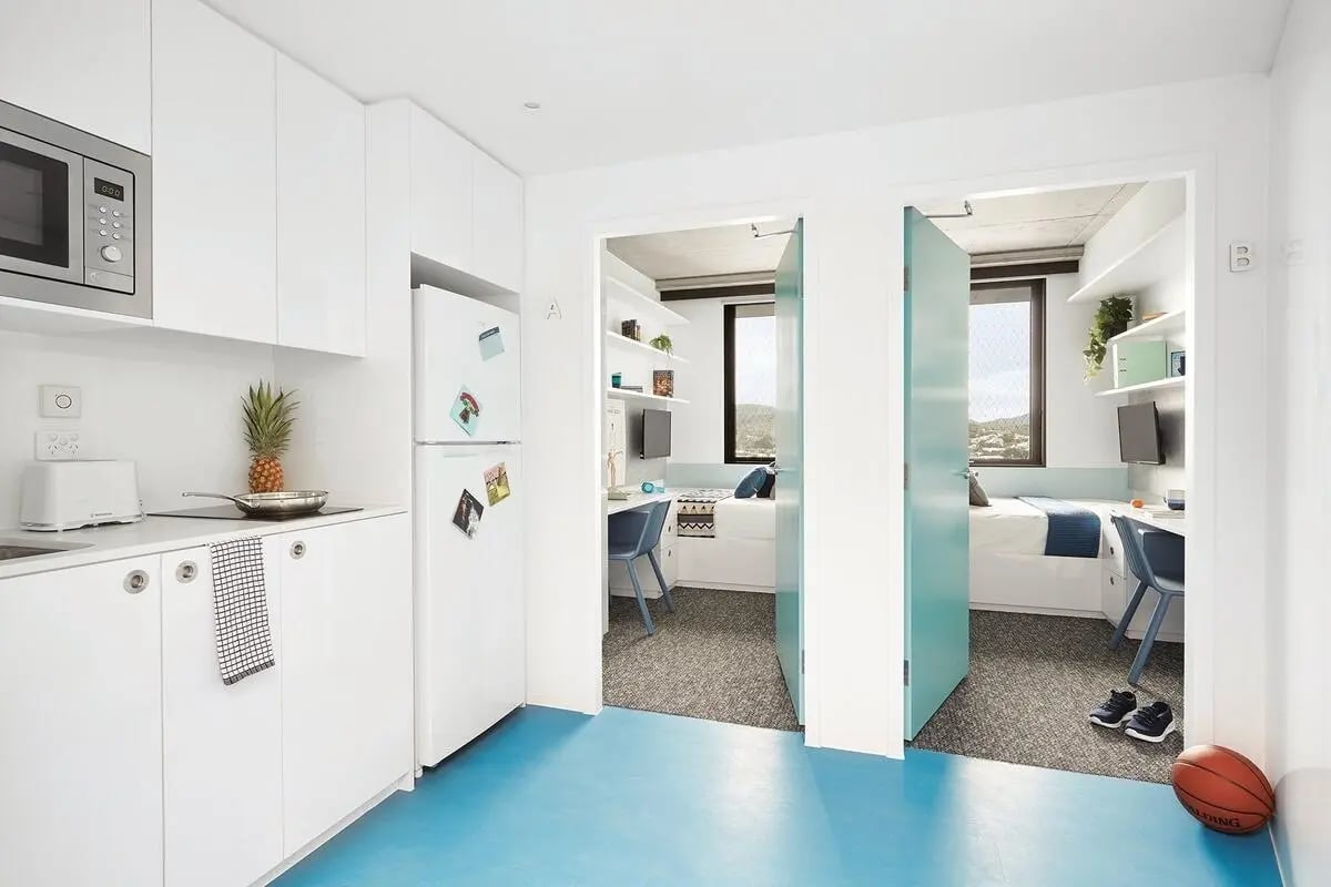 Kitchen area with beds and desks bedroom at Scape Toowong in Brisbane Student Accommodation