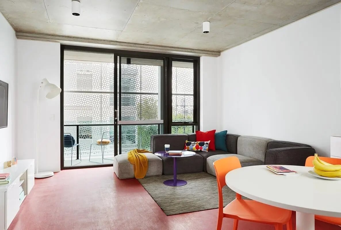 Modern living area with sectional sofa dining table living room at Scape Toowong in Brisbane Student Accommodation