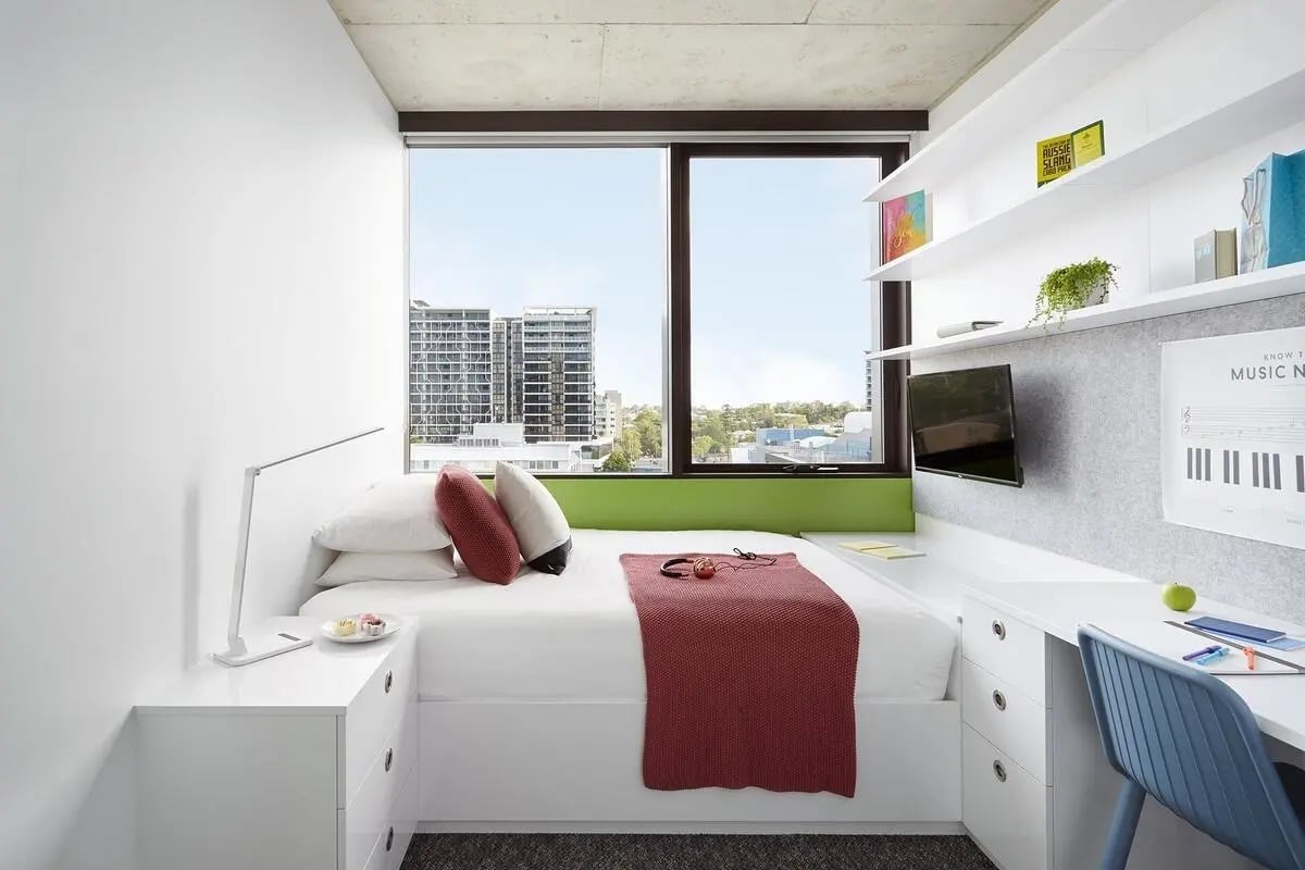 Bed desk shelves and window with city view bedroom at Scape Toowong in Brisbane Student Accommodation