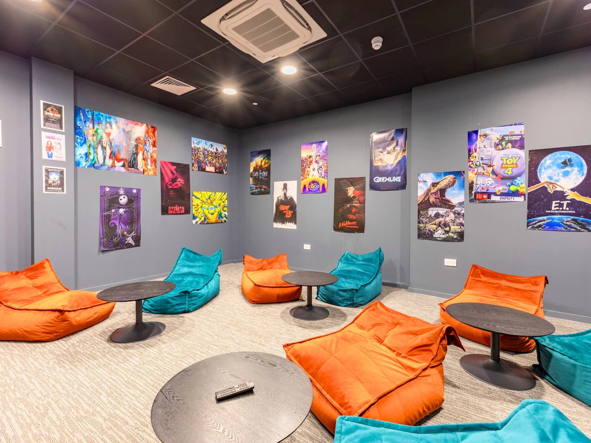 Beanbags and tables with movie posters Playing area at Justice Mill Studios in Aberdeen Student Accommodation
