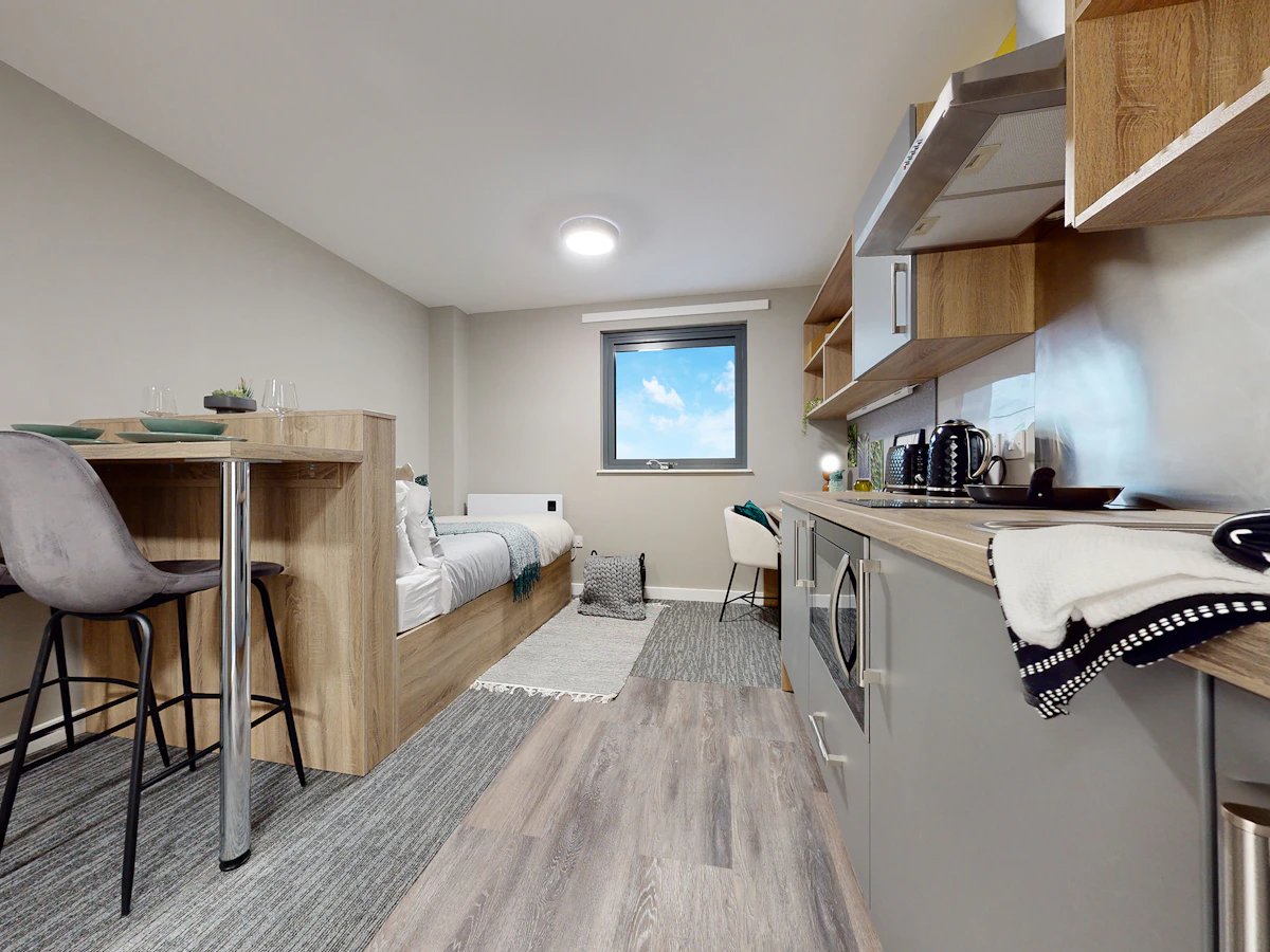 Bed kitchen table with chairs studio apartment at Justice Mill Studios in Aberdeen Student Accommodation