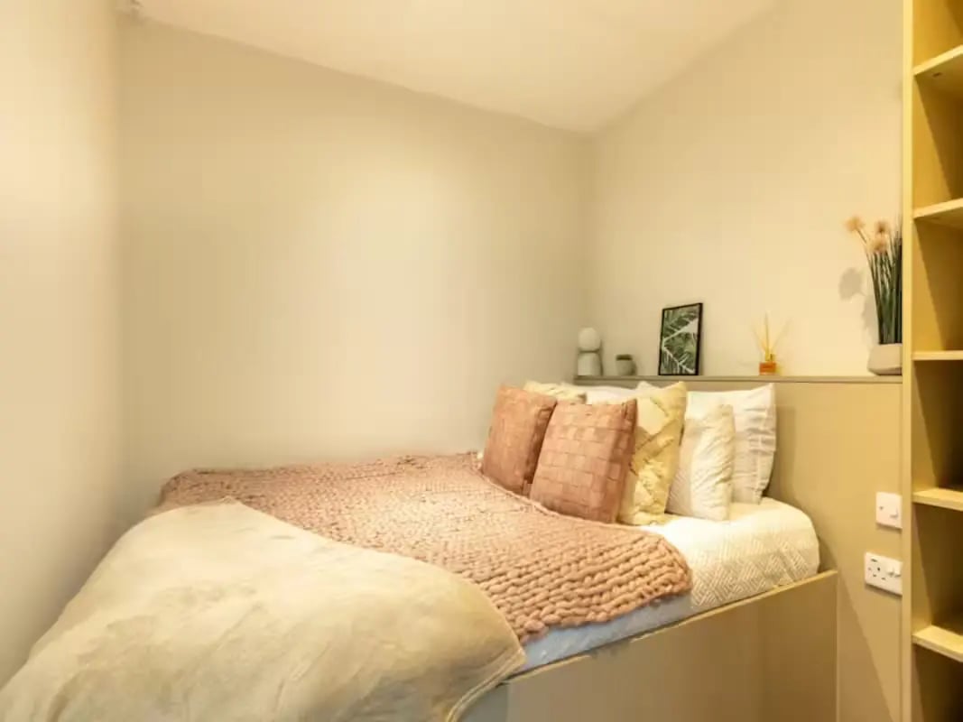 Bed with pillows and blanket on it bedroom at Redvers Tower in Sheffield Student Accommodation