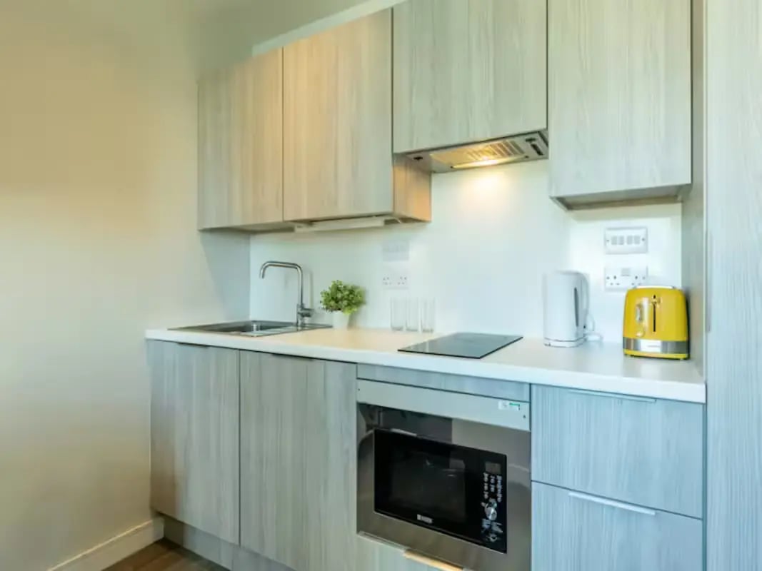 Sink kettle toaster microwave and cabinets kitchen at Redvers Tower in Sheffield Student Accommodation