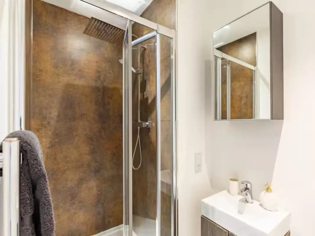 Modern shower cubicle sink and mirror bathroom at Redvers Tower in Sheffield Student Accommodation