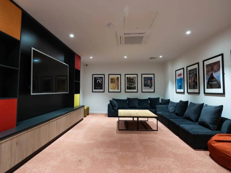 Large sectional couch movie posters and TV living room at Steelworks in Sheffield Student Accommodation