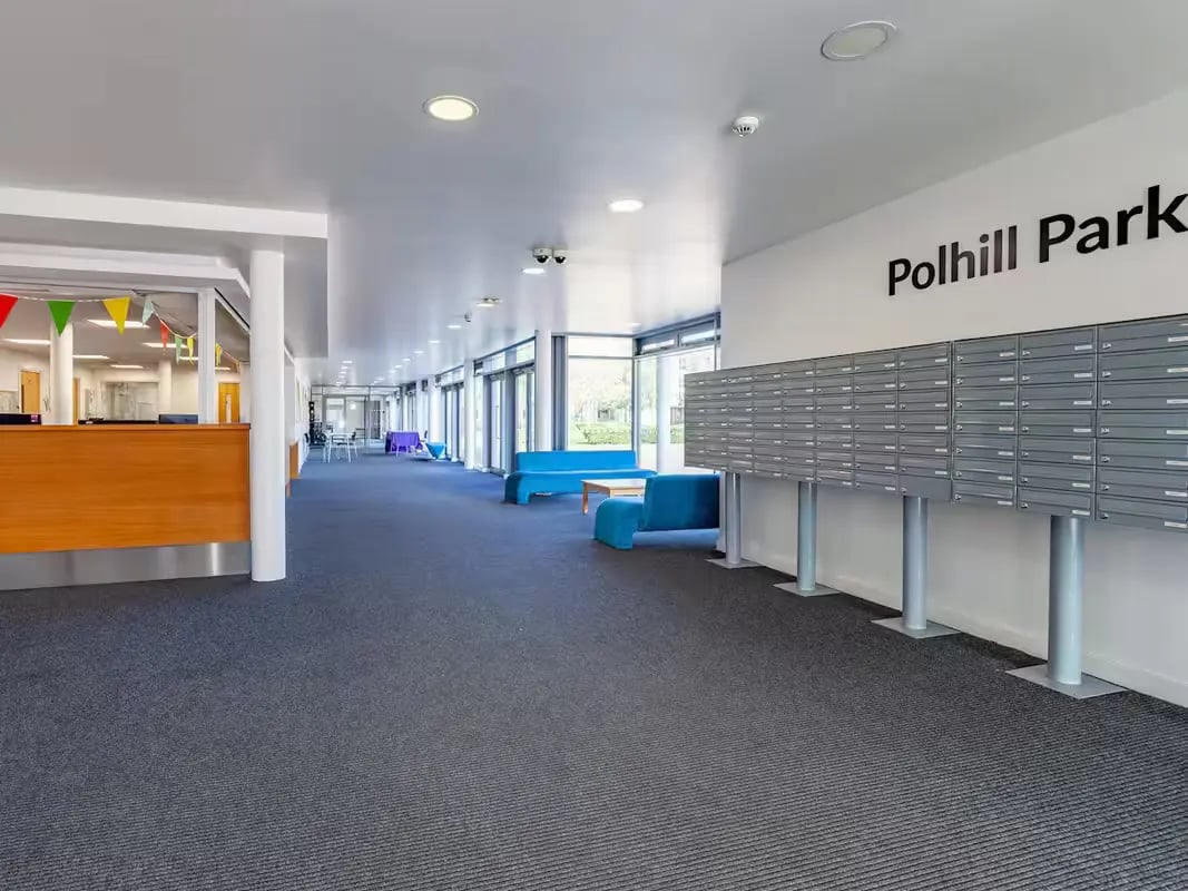 Mailboxes reception desk blue sofas communal area at Polhill Park in Bedford Student Accommodation