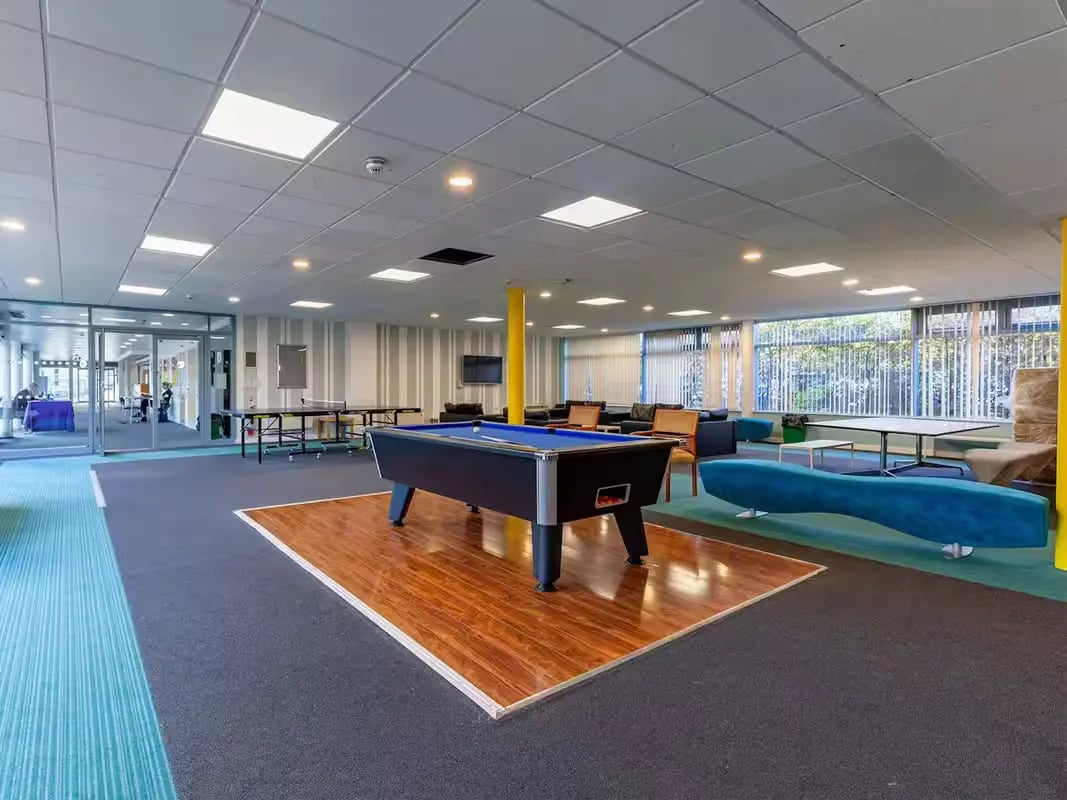 Pool table ping pong tables couches lounge area common room at Polhill Park in Bedford Student Accommodation