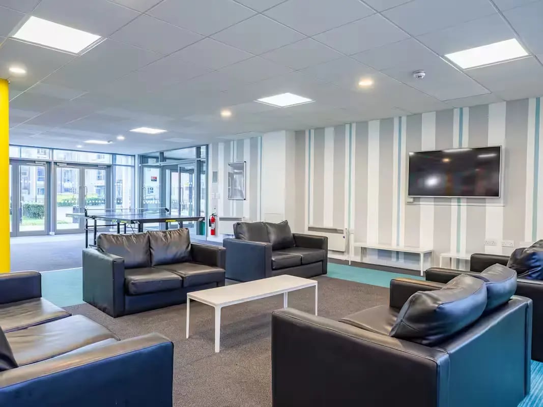 Sofas ping pong table television communal area at Polhill Park in Bedford Student Accommodation