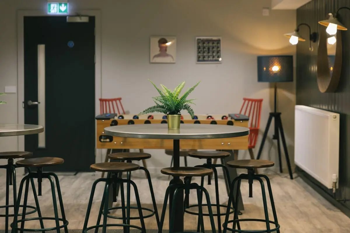 Foosball table plant stools and chairs common area at George Street Apartments in Glasgow Student Accommodation