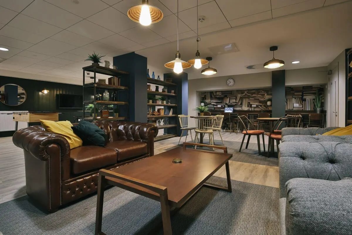 Brown leather sofa with coffee table living room at George Street Apartments in Glasgow Student Accommodation