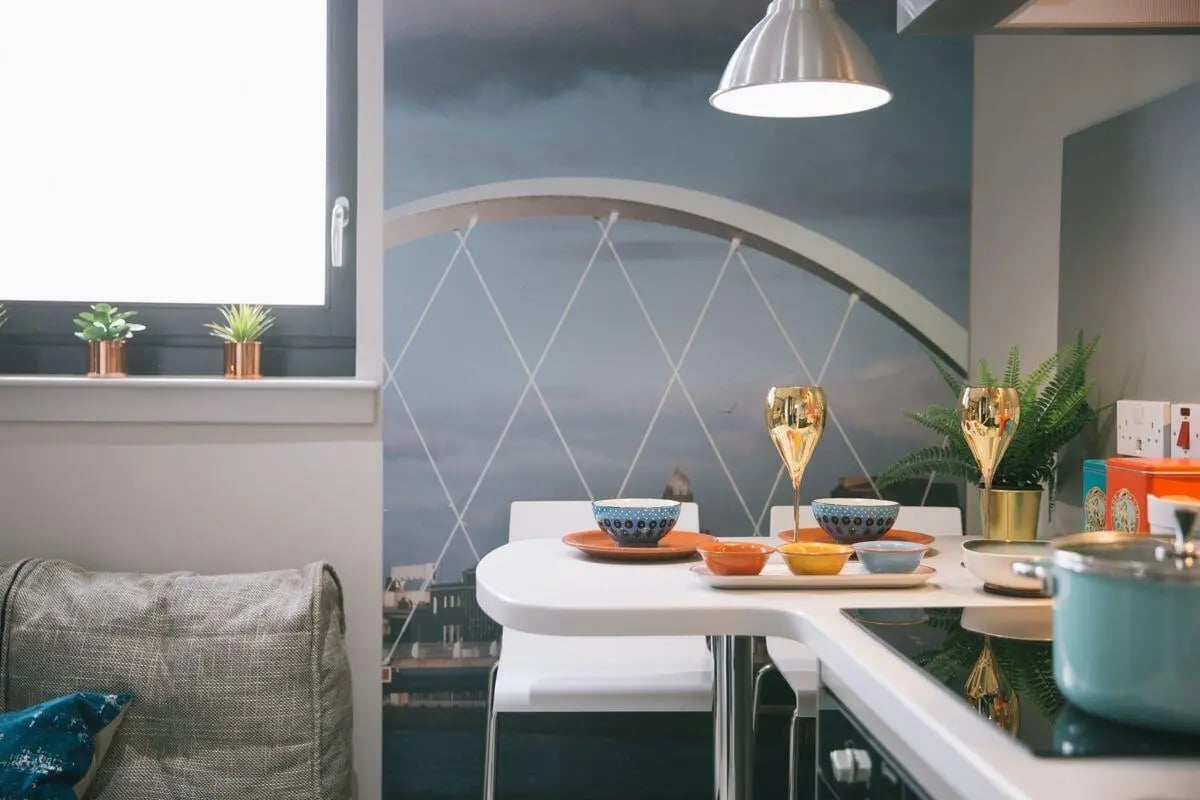 Couch table with bowls glasses plant kitchen at George Street Apartments in Glasgow Student Accommodation