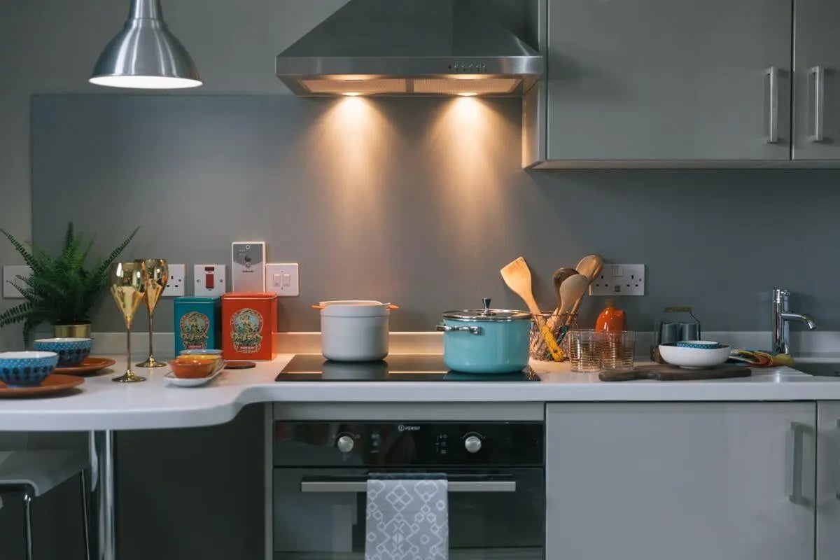 Kitchen counter with pots utensils glasses and plant kitchen at George Street Apartments in Glasgow Student Accommodation
