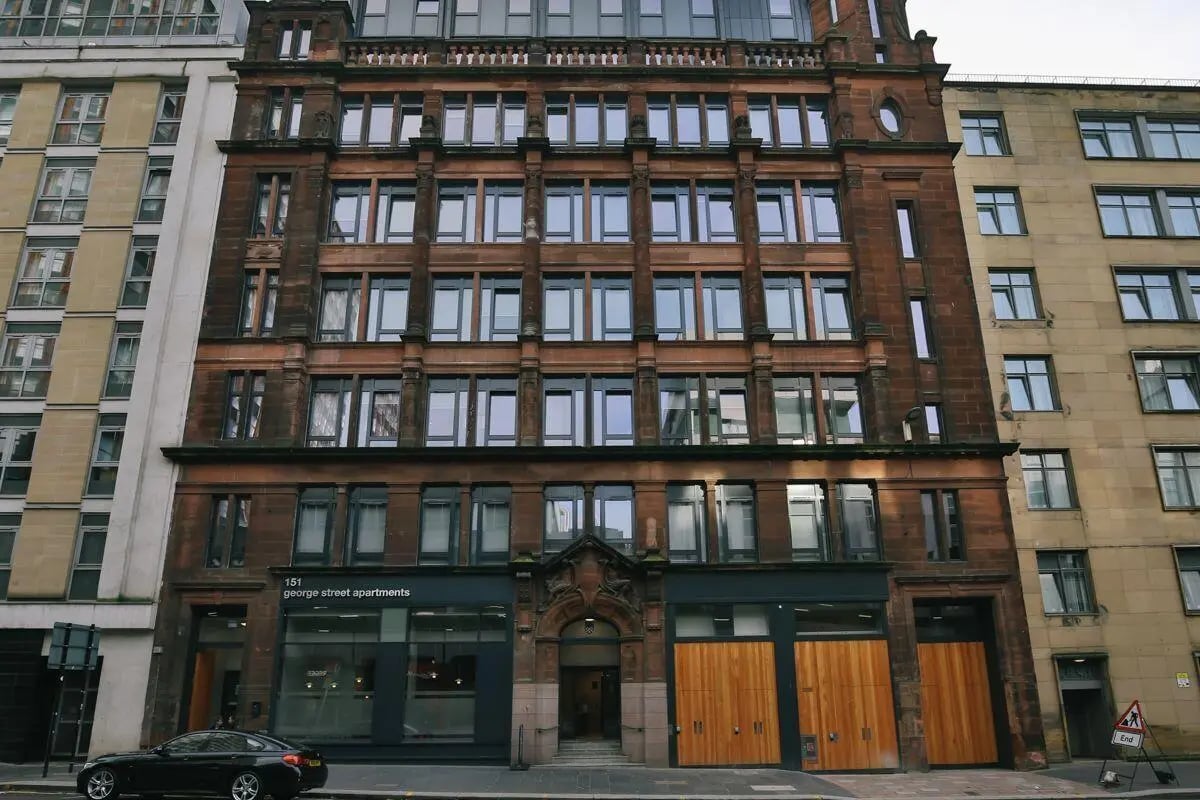 Brown building with large windows exterior at George Street Apartments in Glasgow Student Accommodation