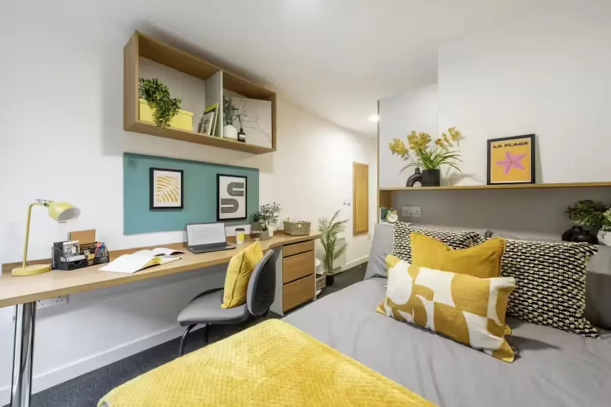 Desk with laptop chair and bed bedroom at The Elements in Sheffield Student Accommodation