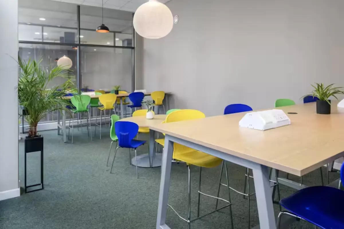 Tables with chairs plant and device common area at The Elements in Sheffield Student Accommodation