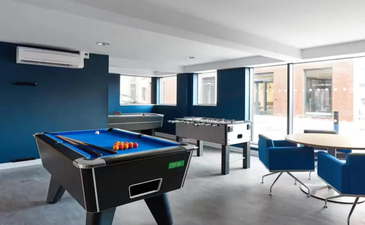 Pool table foosball table chairs table playing area at The Elements in Sheffield Student Accommodation