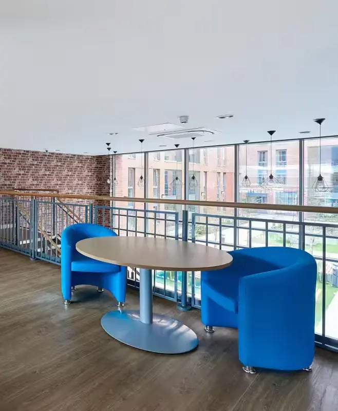 Blue chairs and table in communal area at The Elements in Sheffield Student Accommodation
