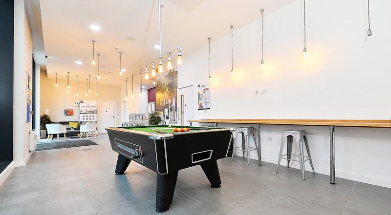 Pool table chairs and counter seating lounge area at 88 Bromsgrove House in Birmingham Student Accommodation
