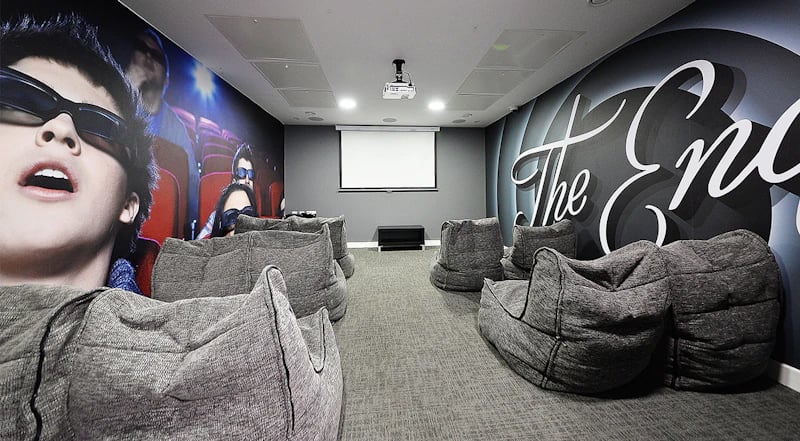 Beanbag chairs surround projector screen cinema room at 88 Bromsgrove House in Birmingham Student Accommodation