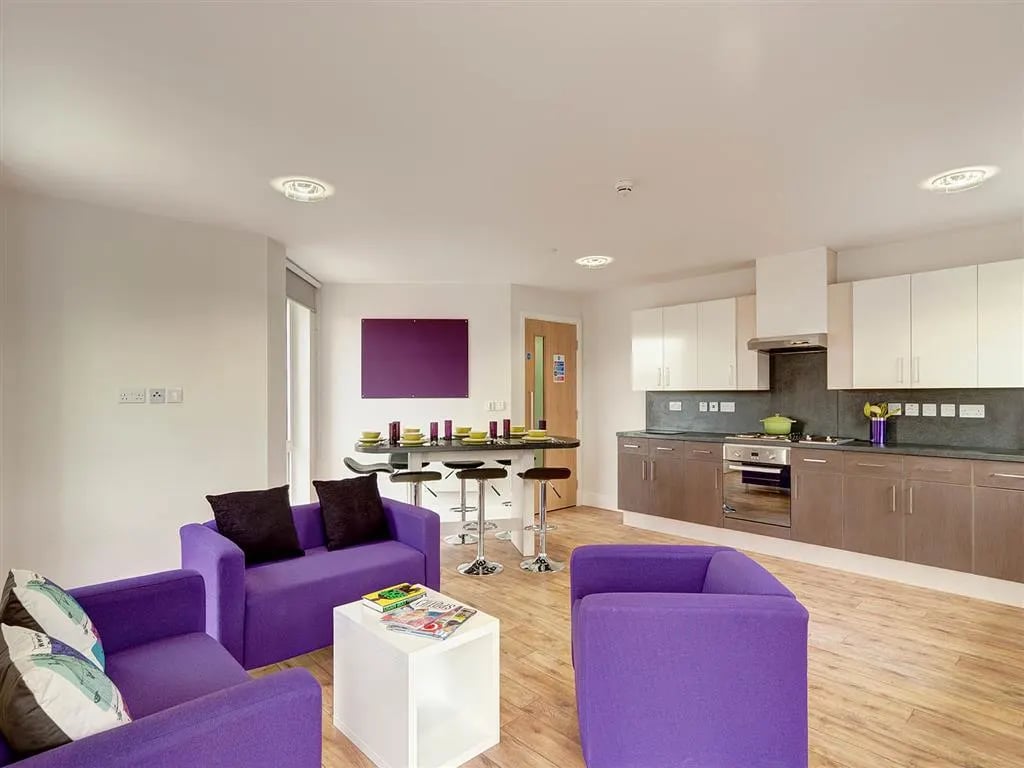 Purple sofas dining bar and kitchen living area at Davidson House in Kingston Upon Thames Student Accommodation