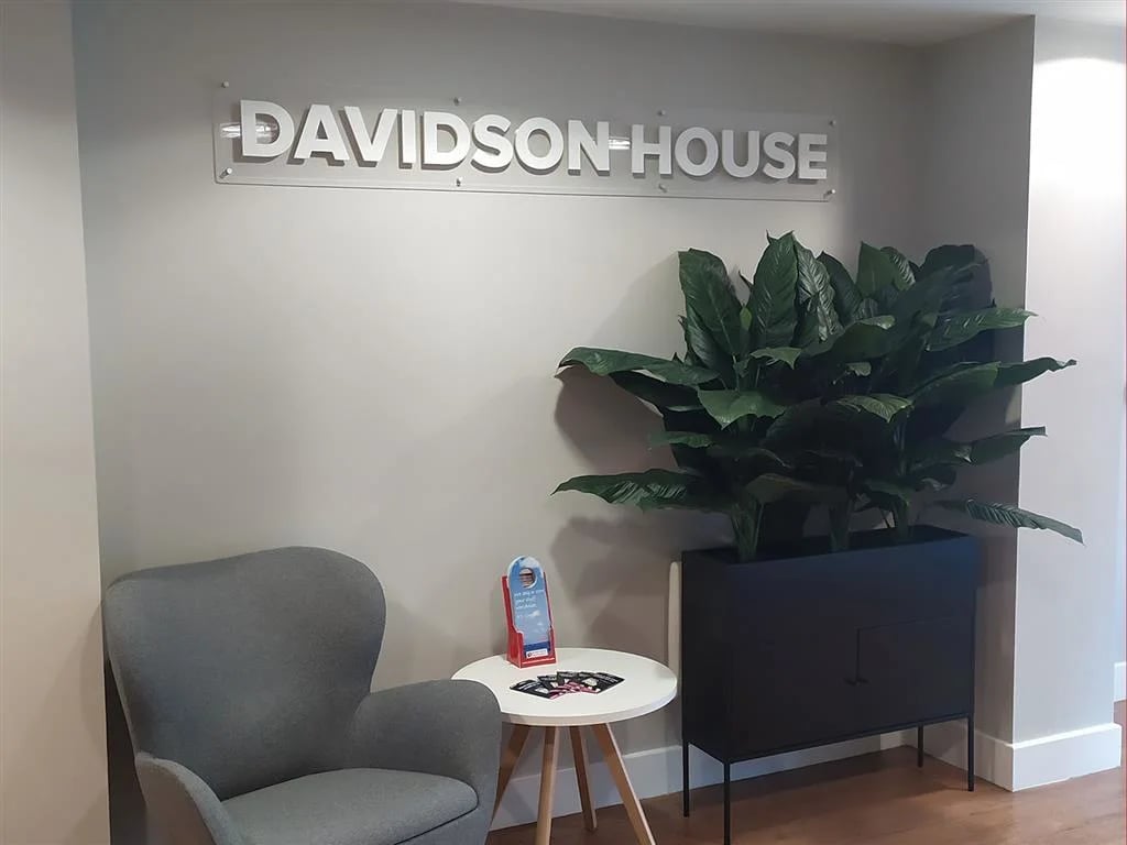Davidson House signage grey armchair plant reception area at Davidson House in Kingston Upon Thames Student Accommodation
