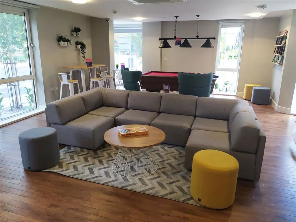 Large sectional sofa billiard table ottomans living room at Davidson House in Kingston Upon Thames Student Accommodation