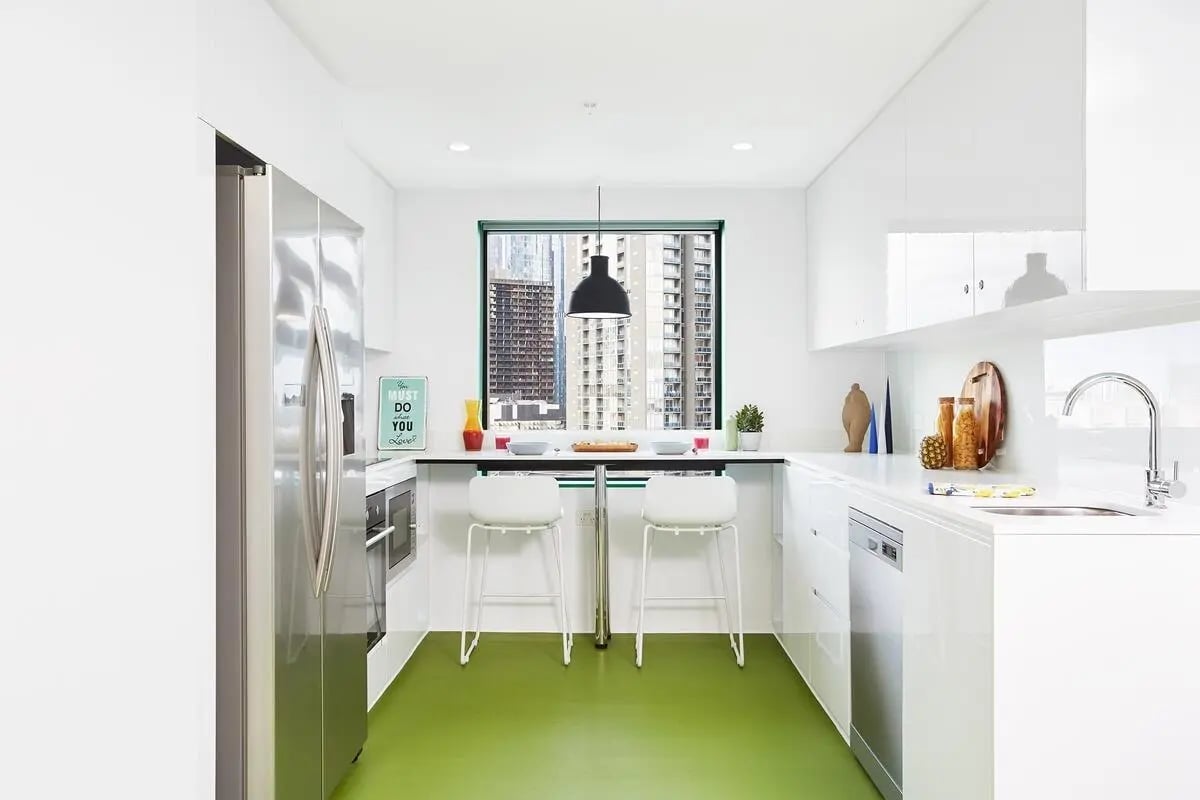 Modern kitchen with fridge dishwasher and stools kitchen at Scape Carlton in Melbourne Student Accommodation