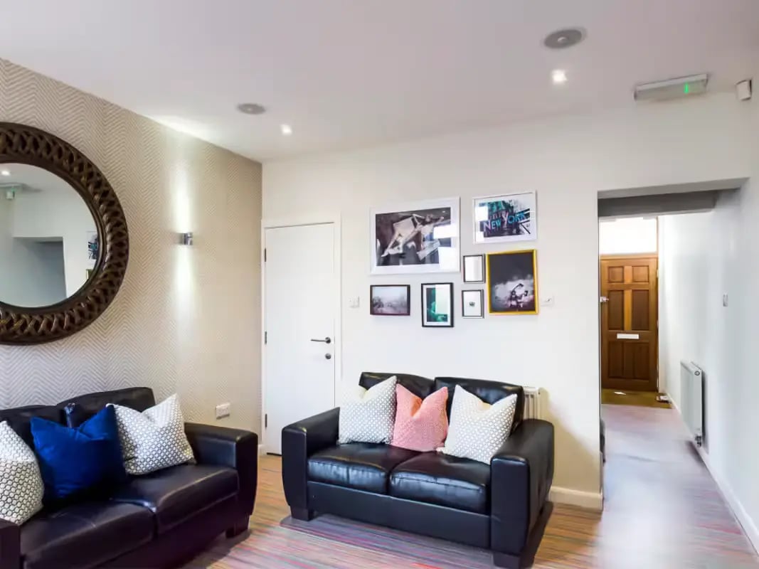 Leather sofas with patterned pillows modern art hallway living room at 85 Seaford Street in Stoke-On-Trent Student Accommodation