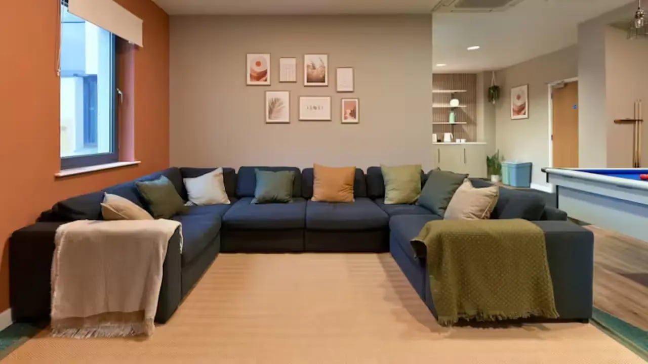 Large sectional sofa with pillows and throws living room at The Apollo Works in Coventry Student Accommodation