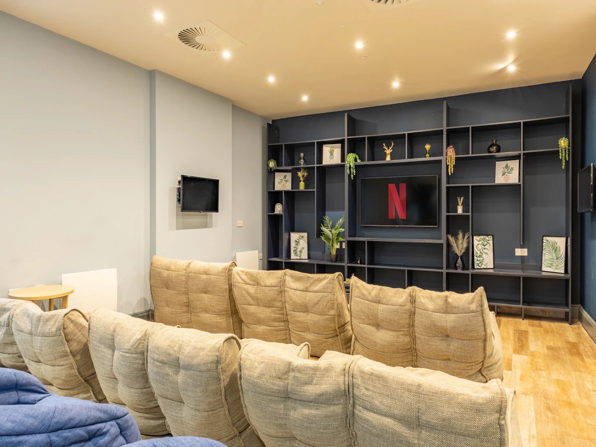Beanbags and sectional sofas facing TV living room at Chamberlain Place in Birmingham Student Accommodation