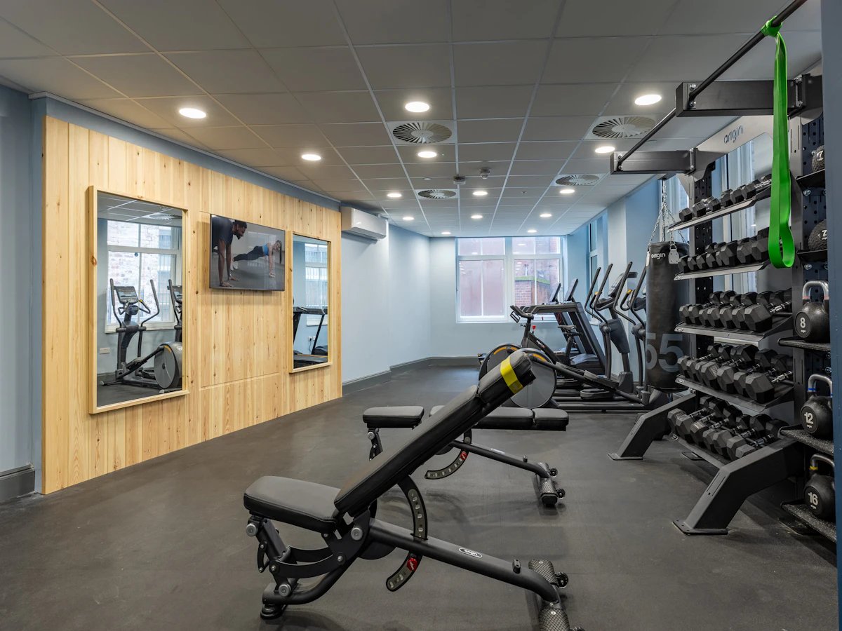 Gym equipment with weights and workout machines fitness room at Chamberlain Place in Birmingham Student Accommodation