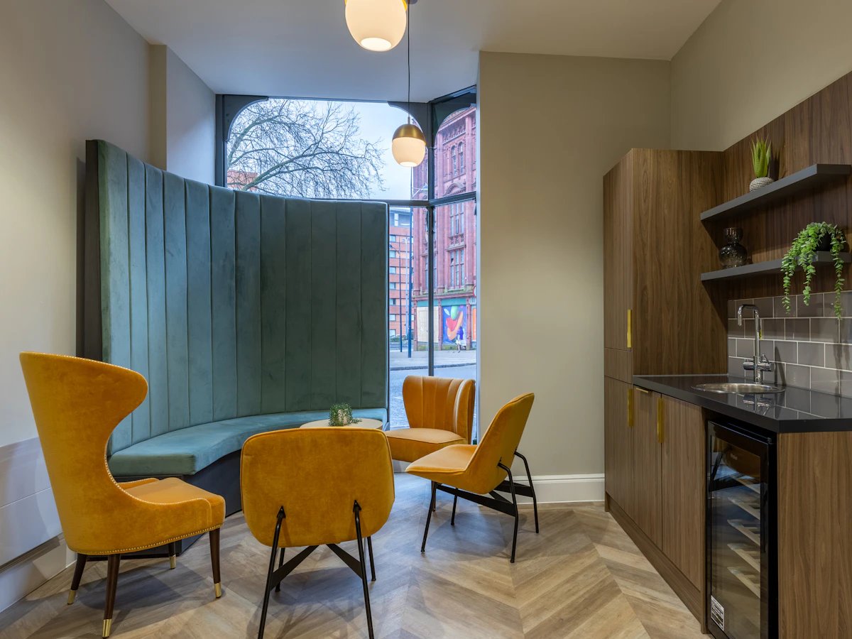 Sofa chairs and kitchen counter living room at Chamberlain Place in Birmingham Student Accommodation