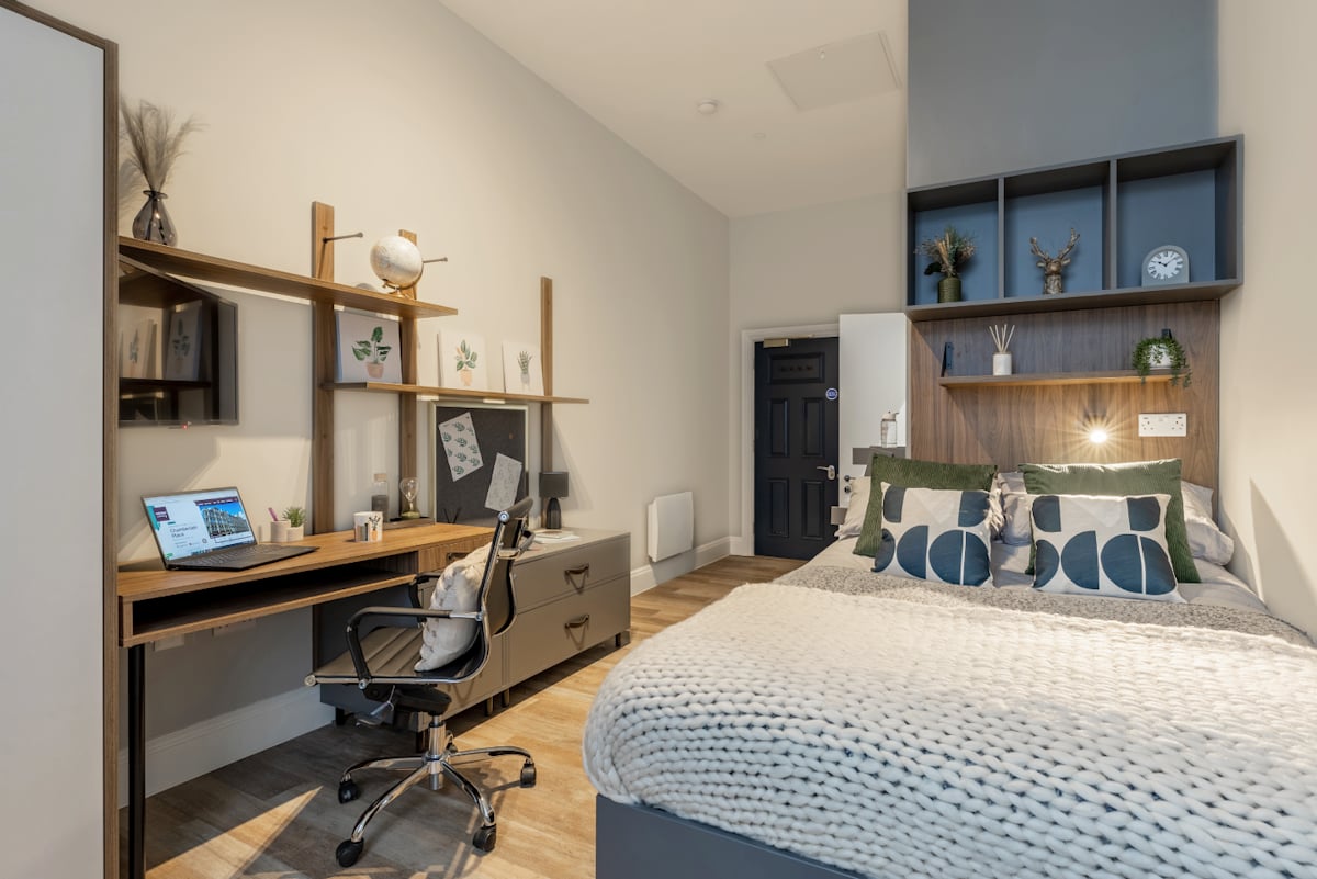 Desk bed with pillows and shelves Bedroom at Chamberlain Place in Birmingham Student Accommodation