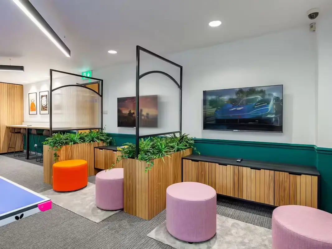 Plants ottomans screens TVs and cabinets communal area at Calthorpe Court in Birmingham Student Accommodation
