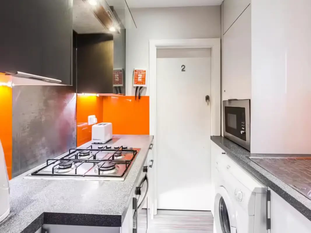 Kitchen with hob toaster microwave and washing machine kitchen at 93 Thornton Road in Stoke-On-Trent Student Accommodation