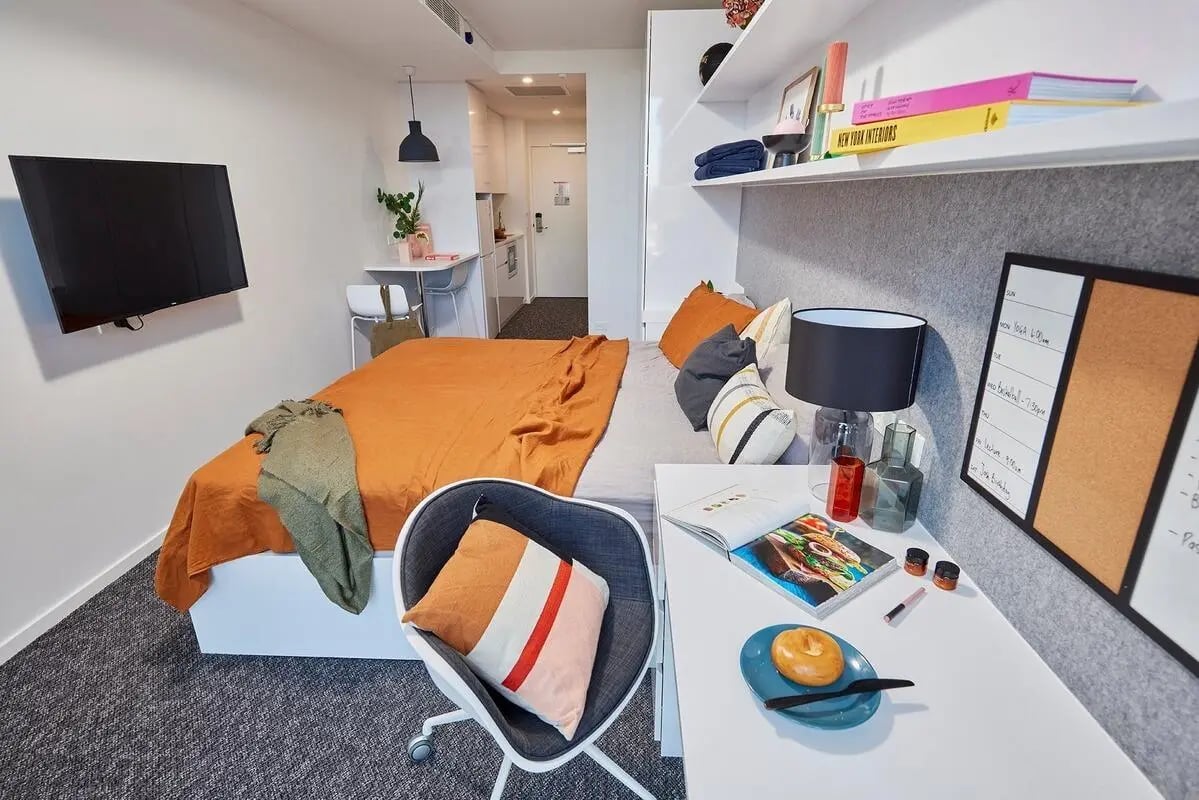 Bed desk lamp and television student room at Scape Redfern in Sydney Student Accommodation