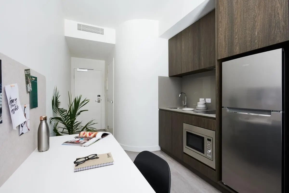 Desk with whiteboard fridge and microwave kitchen at Scape Cornell Place in Melbourne Student Accommodation