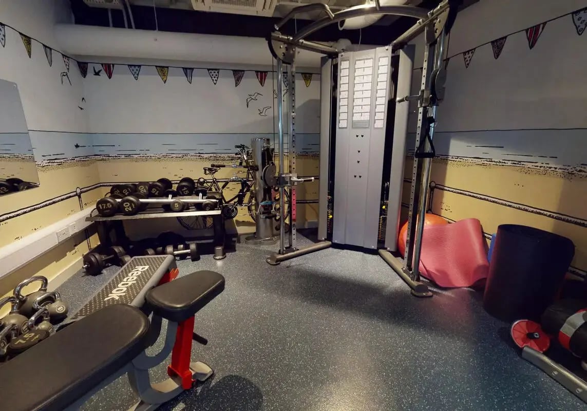 Weights machine dumbbells bench and bicycle gym at iQ Bristol in Bristol Student Accommodation