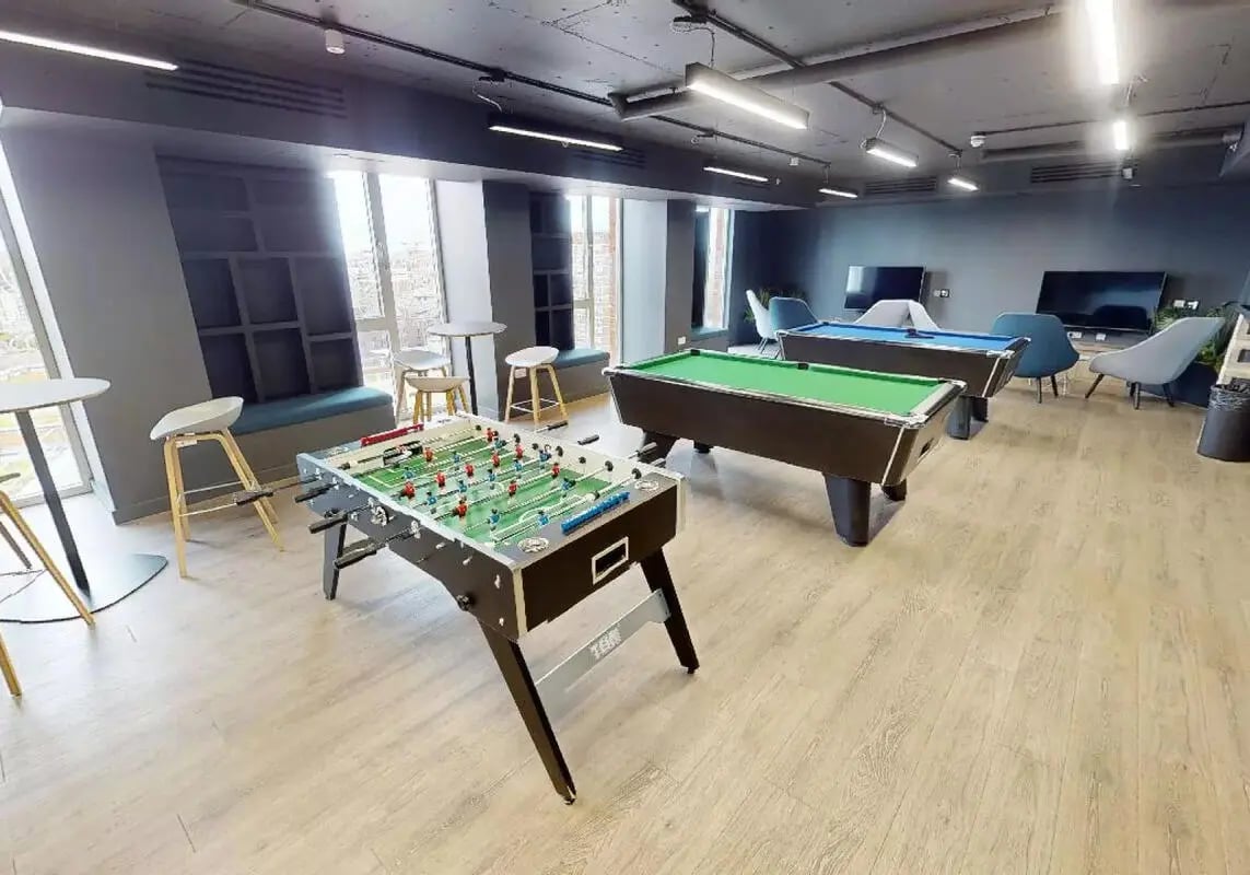 Foosball table pool tables lounge chairs recreation area at iQ Shoreditch in London Student Accommodation