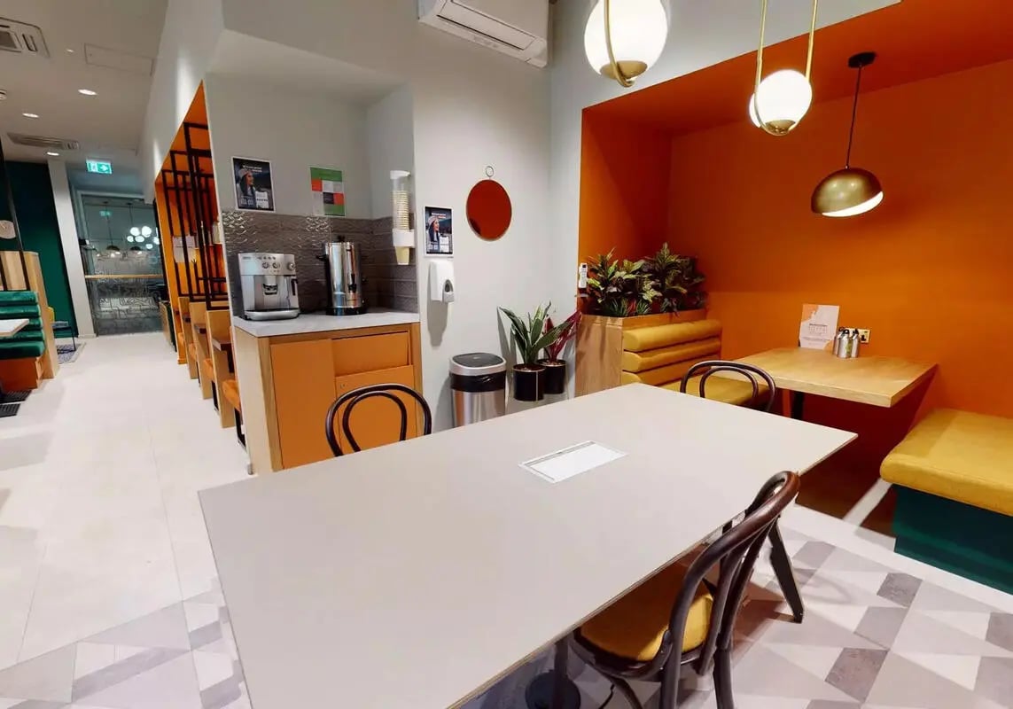 Table coffee maker chairs and dining area at iQ Bloomsbury in London Student Accommodation