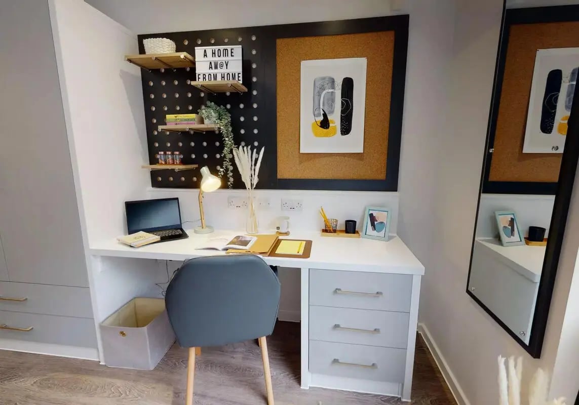 Desk with laptop chair and shelves study area at iQ Bloomsbury in London Student Accommodation