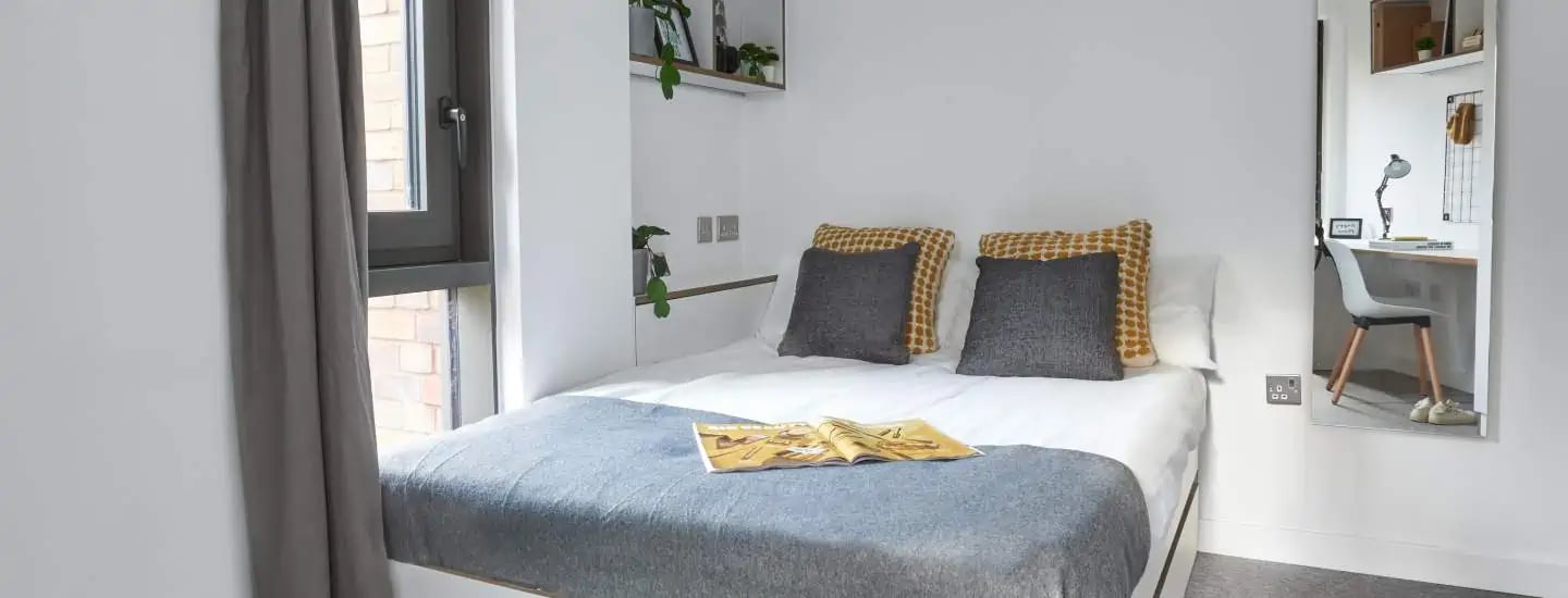 Bed with pillows desk with chair bedroom study area at The Glassworks Leicester in Leicester Student Accommodation