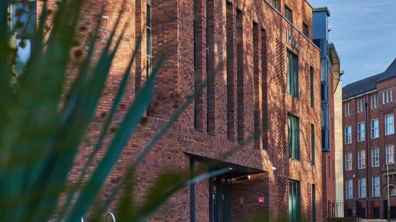 Brick building with windows and plants exterior at The Glassworks Leicester in Leicester Student Accommodation