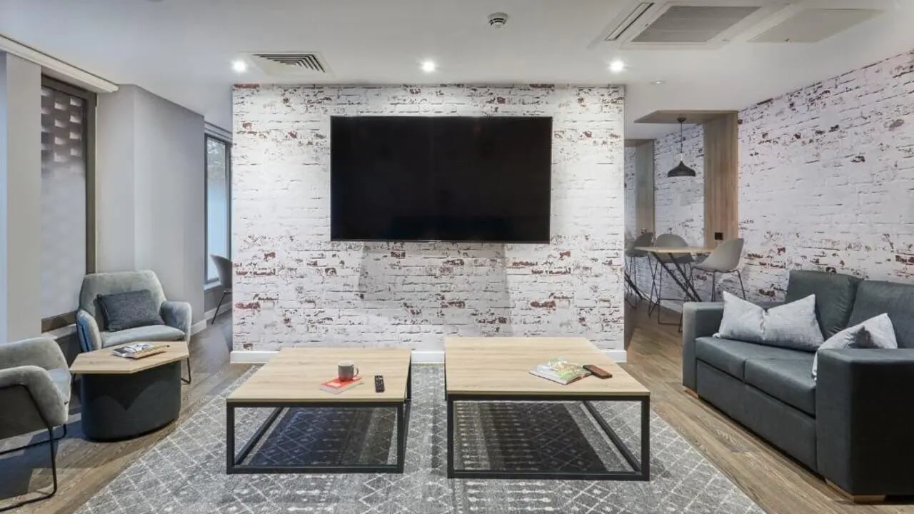 Sofa armchair coffee tables television living room at The Glassworks Leicester in Leicester Student Accommodation