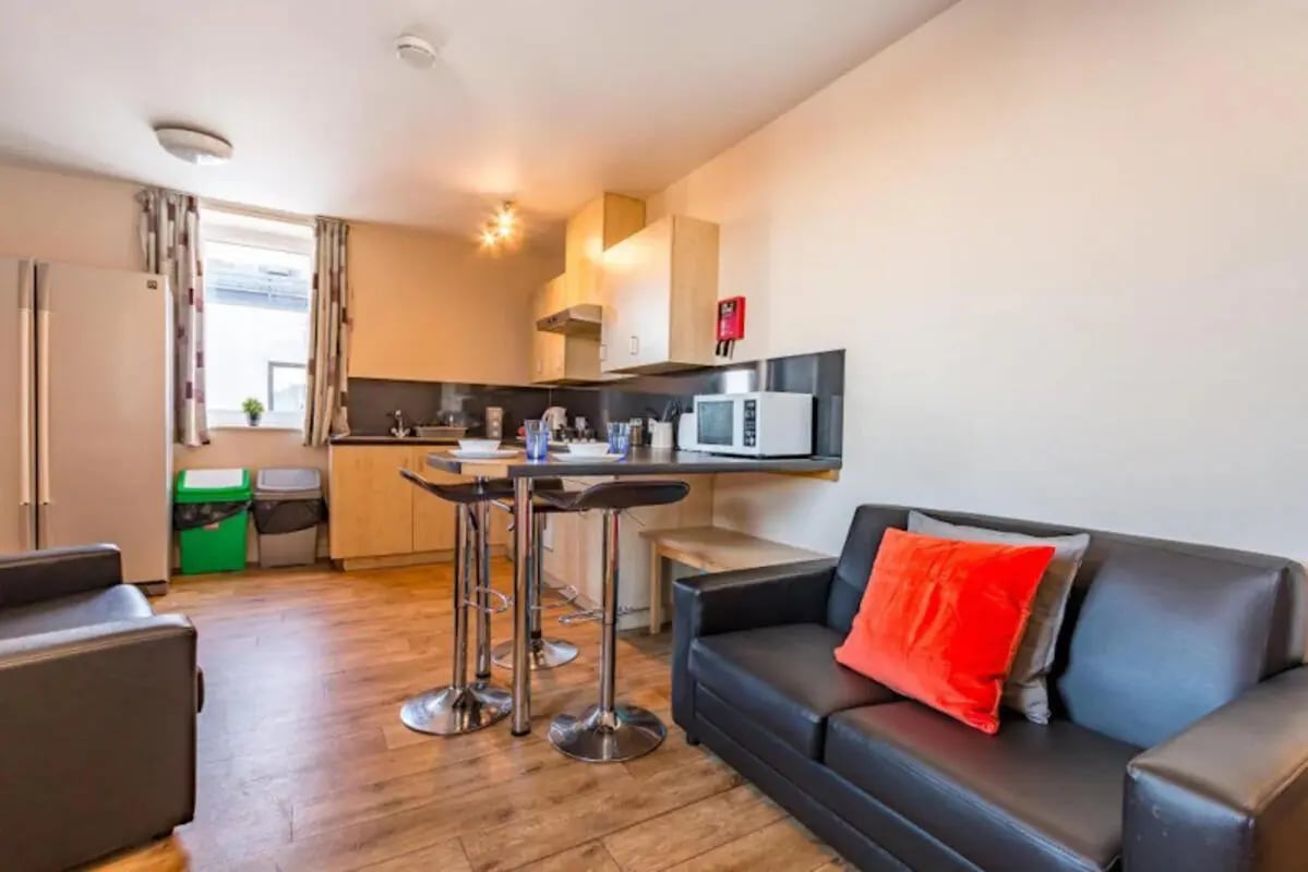 Sofa microwave bar stools and kitchen living room at Chambers 51 in Wolverhampton Student Accommodation