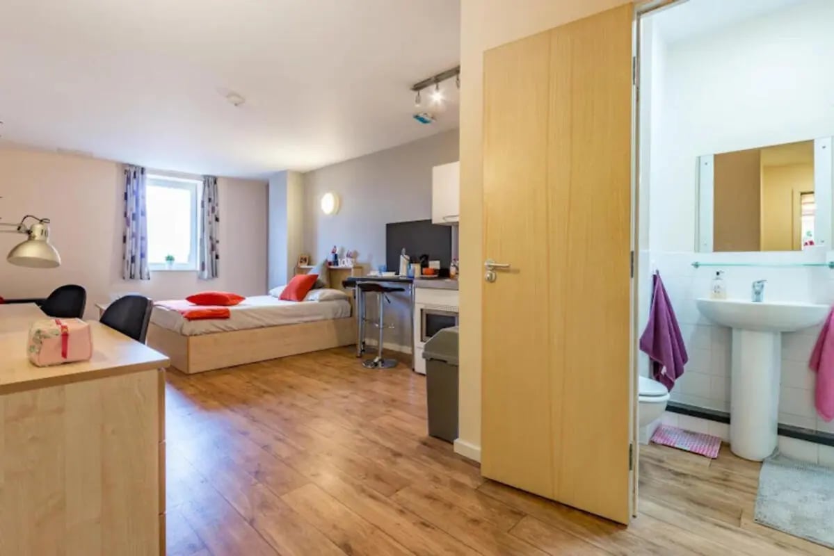 Bed desk kitchen area and bathroom bedroom at Chambers 51 in Wolverhampton Student Accommodation