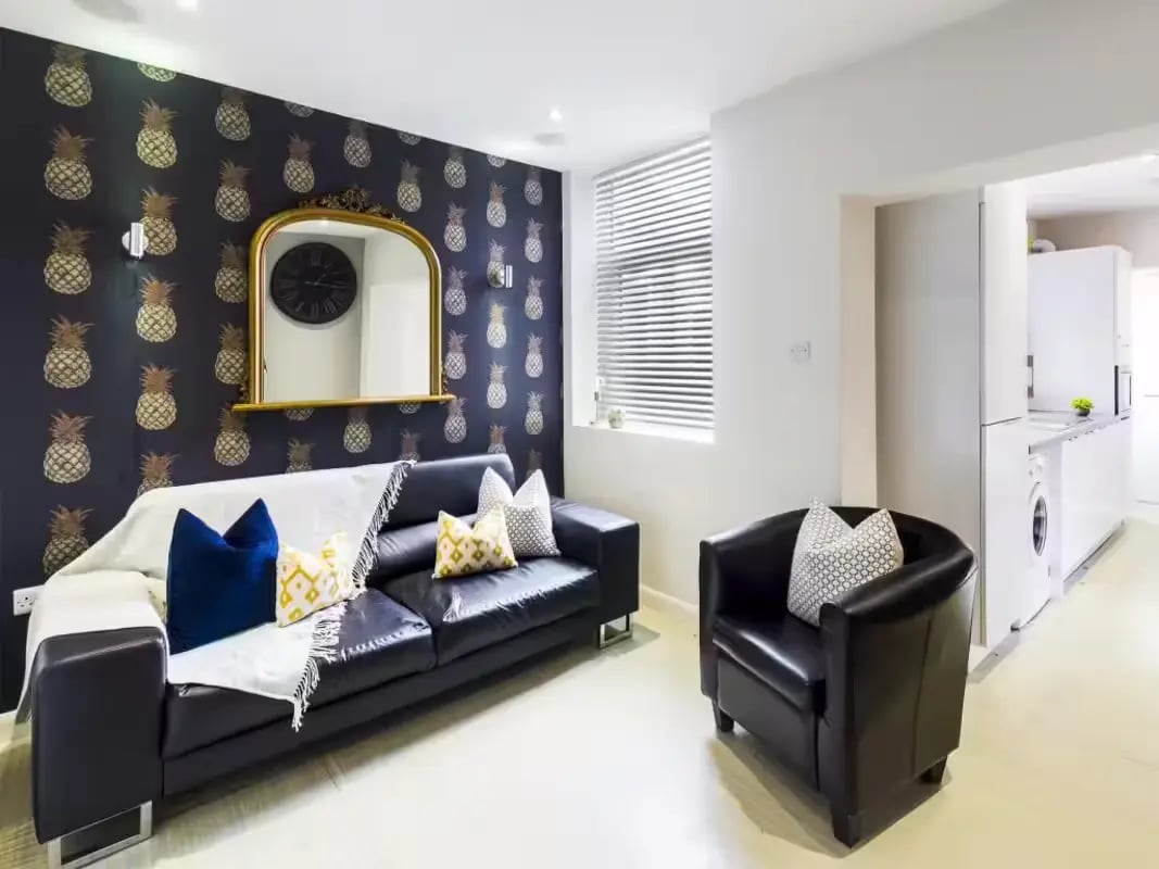 Black leather sofa with pillows living room at 31 Guildford Street in Stoke-On-Trent Student Accommodation