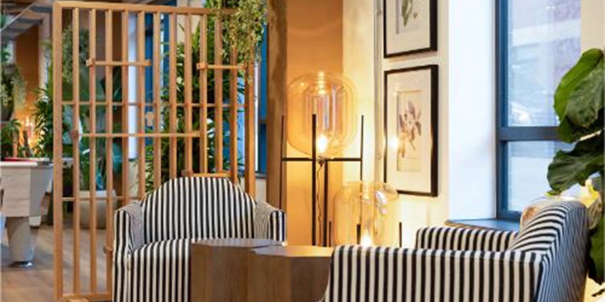Striped armchairs table lamps framed art living area at Canvas Bristol in Bristol Student Accommodation
